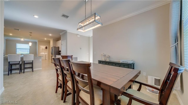 dining room featuring crown molding