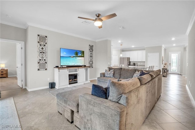 17250 Ashcomb Way, Estero, FL 33928 - living room featuring crown molding, light tile patterned floors, ceiling fan, baseboards, and a glass covered fireplace