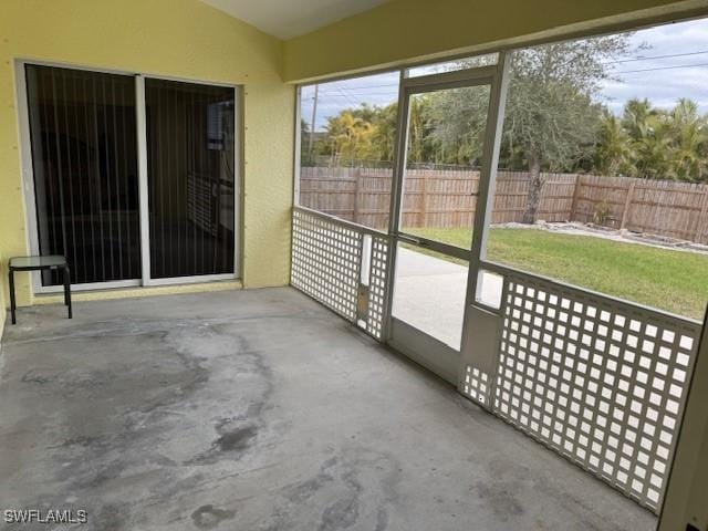 unfurnished sunroom with lofted ceiling