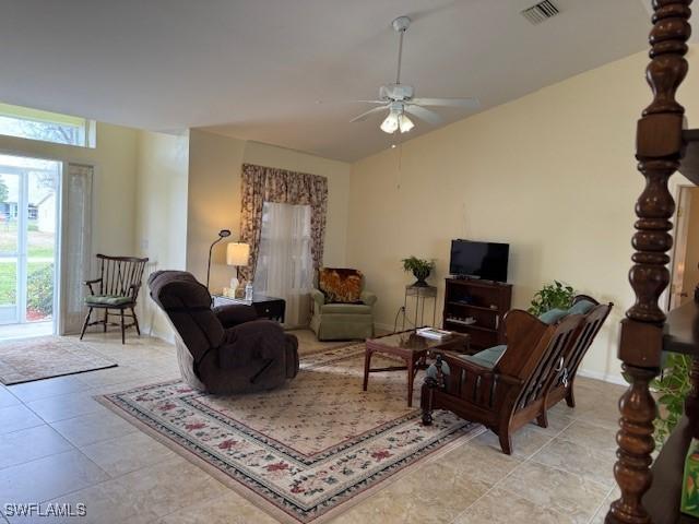 tiled living room featuring ceiling fan