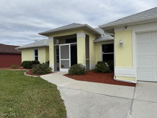 entrance to property with a lawn