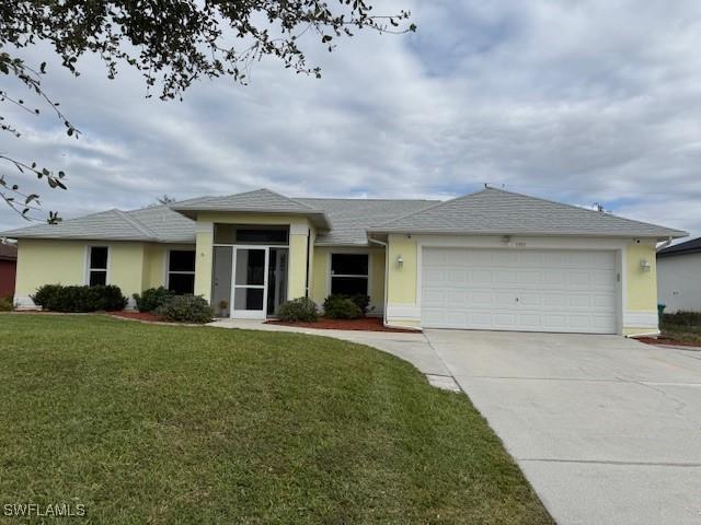 view of front of property featuring an attached garage, a front lawn, concrete driveway, and stucco siding