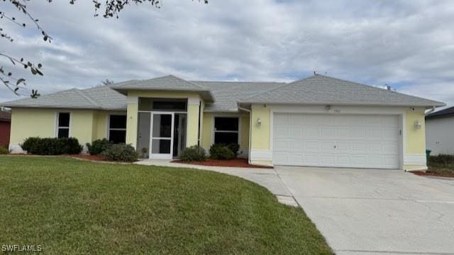 ranch-style house with a front yard, concrete driveway, and an attached garage