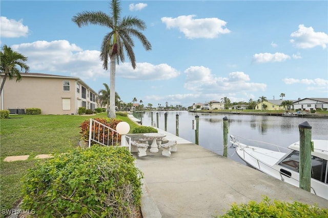 dock area featuring a water view and a lawn