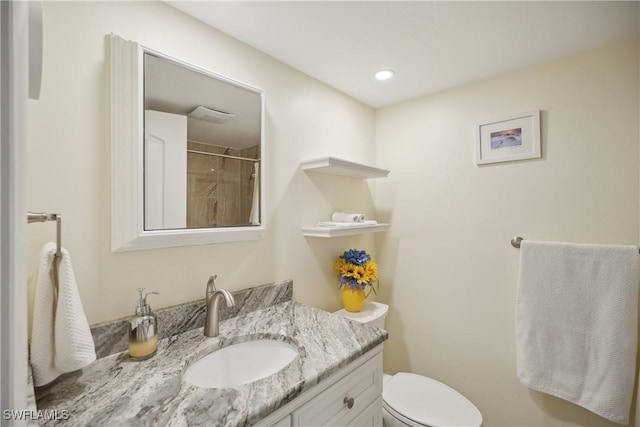 bathroom with vanity, toilet, and walk in shower