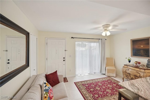 living room featuring ceiling fan and light tile patterned floors