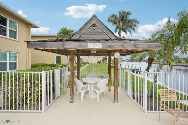 view of patio / terrace with a gazebo and a water view