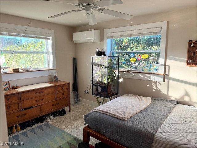 bedroom with ceiling fan and a wall unit AC