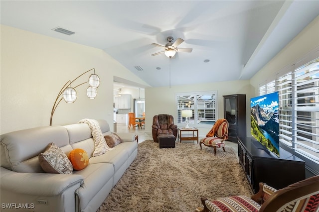 living room with ceiling fan and vaulted ceiling