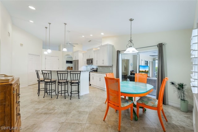 dining room featuring ceiling fan and lofted ceiling