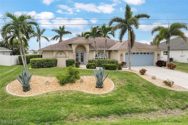 view of front of home with a garage and a front lawn