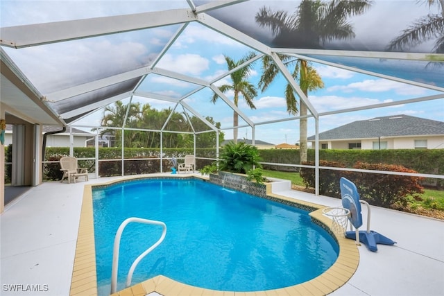 view of pool with a lanai, pool water feature, and a patio