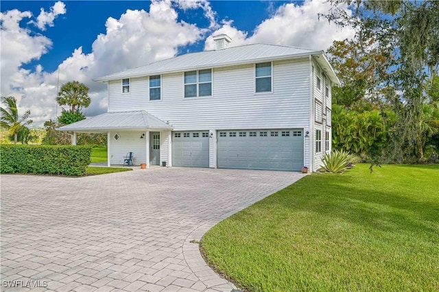 view of front of house with a garage and a front lawn