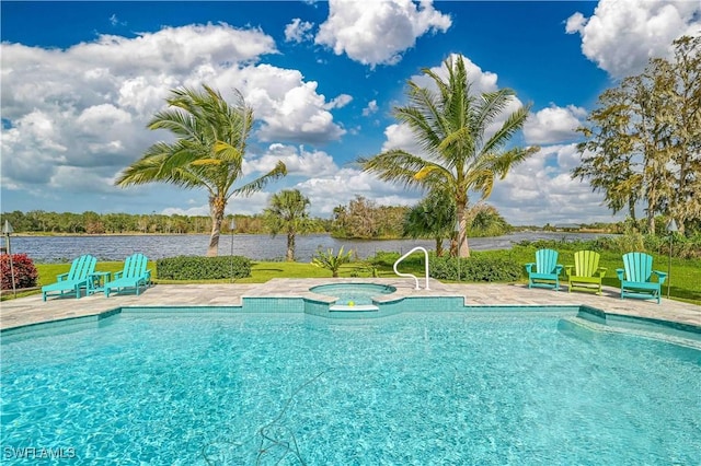 view of swimming pool featuring an in ground hot tub, a patio area, and a water view