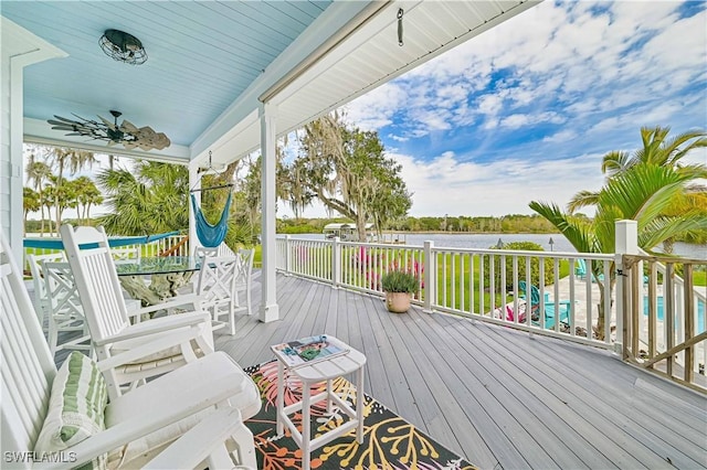 wooden deck with a water view and a porch