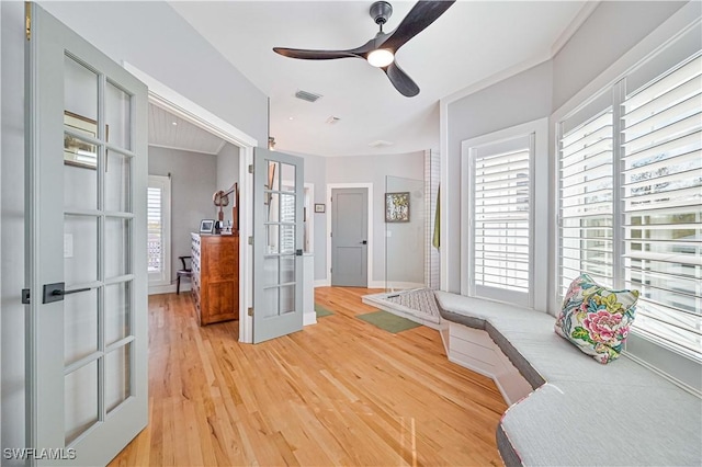 sitting room with ceiling fan, hardwood / wood-style floors, and french doors