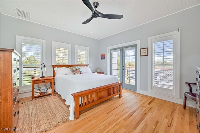 bedroom with light hardwood / wood-style floors, ceiling fan, french doors, and access to outside