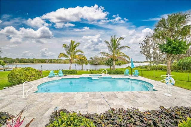 view of pool featuring an in ground hot tub, a patio area, a water view, and a yard