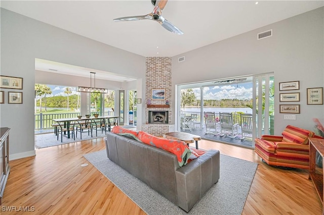 living room featuring ceiling fan, light hardwood / wood-style floors, and plenty of natural light