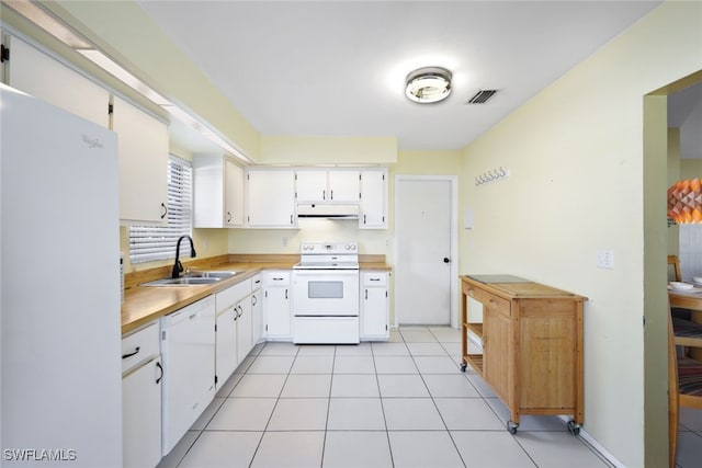 kitchen with white cabinets, white appliances, sink, and light tile patterned floors