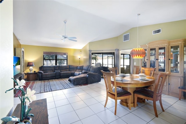 dining space with light tile patterned floors, ceiling fan, and lofted ceiling