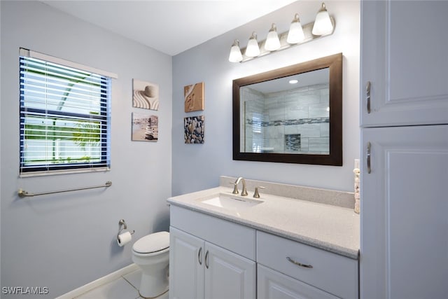 bathroom featuring a shower, tile patterned flooring, vanity, and toilet