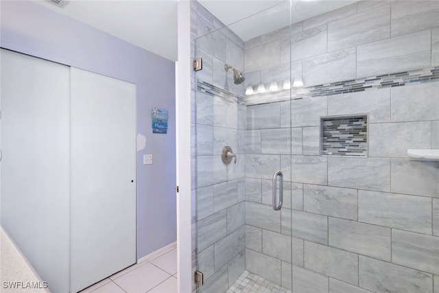 bathroom with tile patterned floors and a shower with shower door