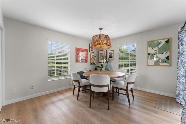 dining area featuring light wood-type flooring and a wealth of natural light