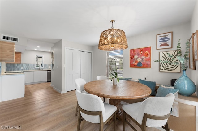 dining room with light wood-type flooring and sink