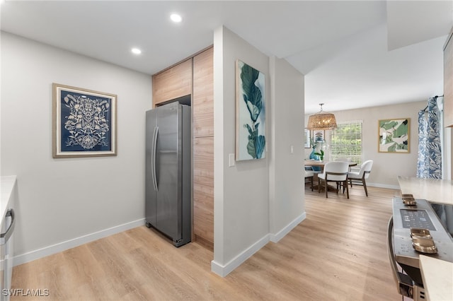 corridor with light hardwood / wood-style floors