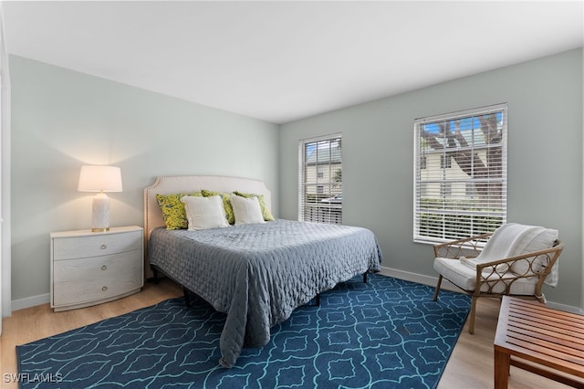 bedroom with dark hardwood / wood-style floors