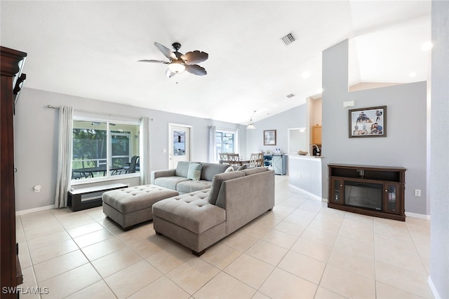 tiled living room with ceiling fan, a healthy amount of sunlight, and lofted ceiling