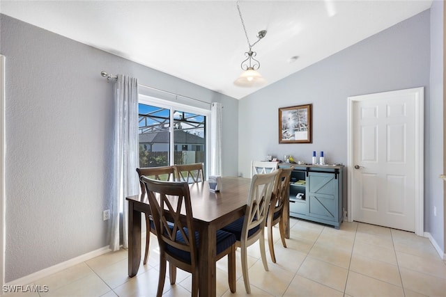 dining room with light tile patterned flooring and lofted ceiling