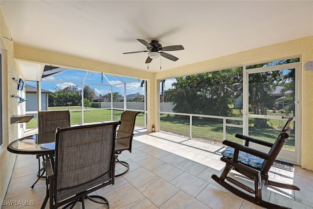 sunroom / solarium featuring ceiling fan