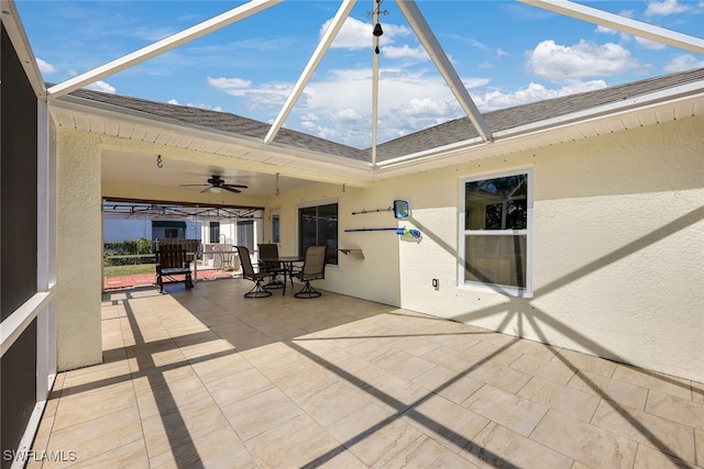 view of patio / terrace featuring ceiling fan and a lanai