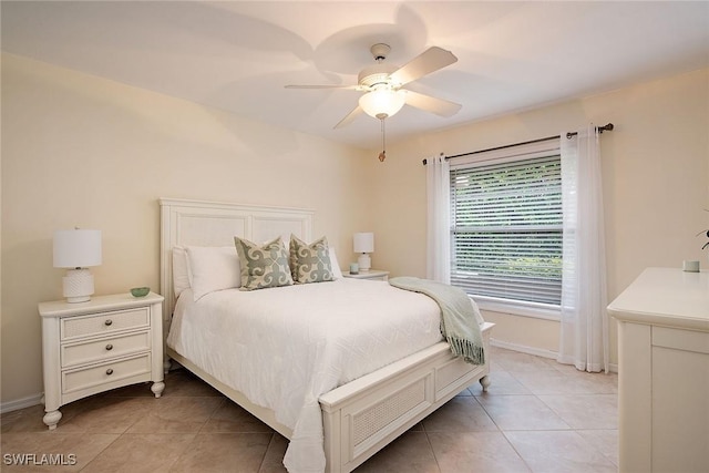 tiled bedroom featuring ceiling fan