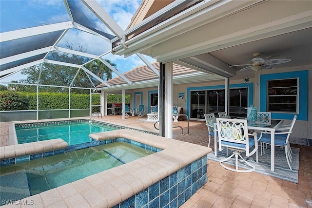 view of pool with glass enclosure, an in ground hot tub, a patio area, and ceiling fan