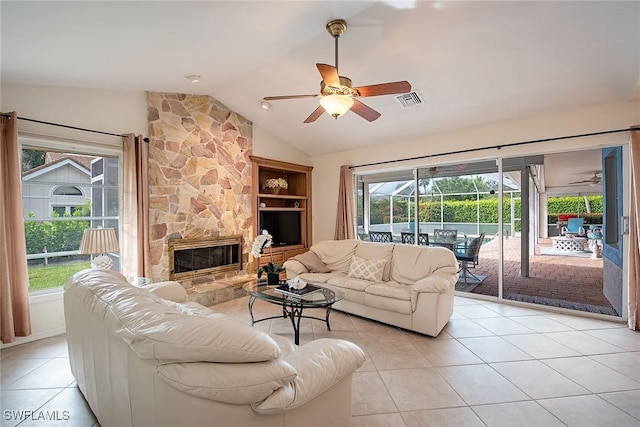 tiled living room with a fireplace, built in features, ceiling fan, and lofted ceiling