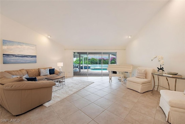 living area featuring high vaulted ceiling, a sunroom, and light tile patterned floors