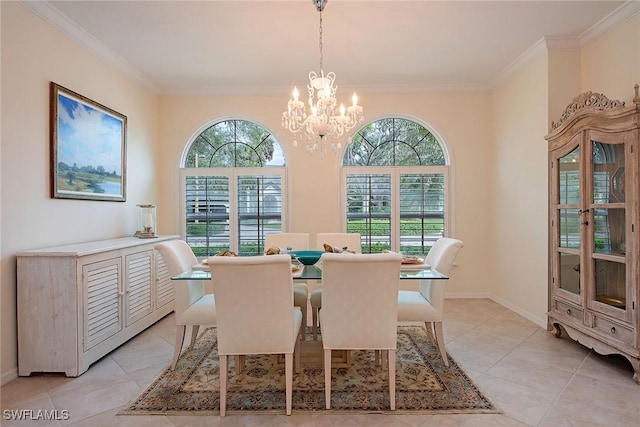 dining space with a healthy amount of sunlight, ornamental molding, and a notable chandelier