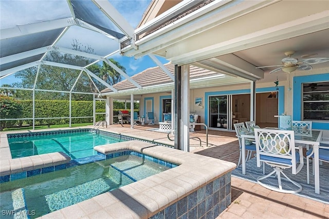 pool with a lanai, a patio area, ceiling fan, and an in ground hot tub