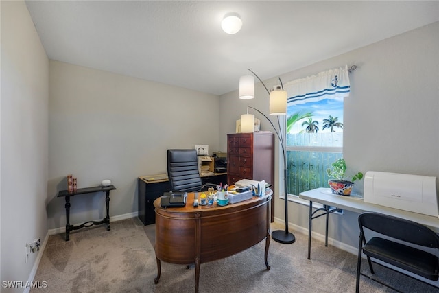 carpeted office space featuring baseboards