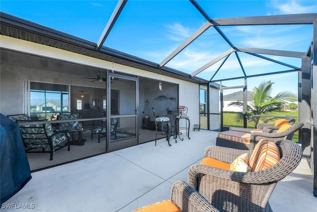 view of patio featuring glass enclosure and outdoor lounge area