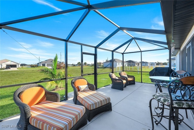 view of patio featuring a residential view and glass enclosure