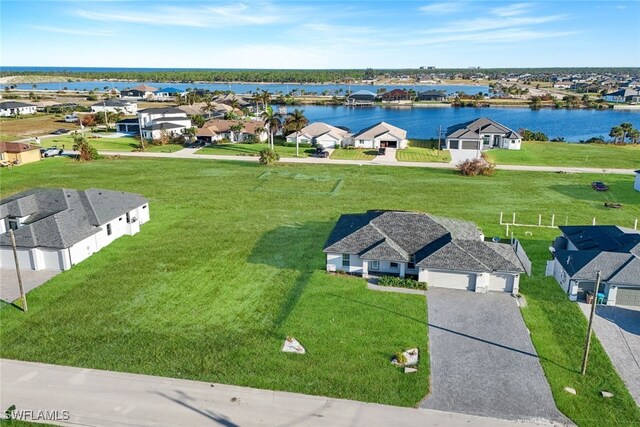 bird's eye view with a water view and a residential view