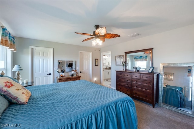 bedroom featuring ceiling fan, carpet, ensuite bath, and visible vents