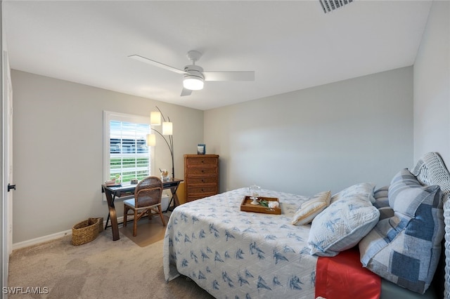 bedroom with baseboards, a ceiling fan, visible vents, and light colored carpet