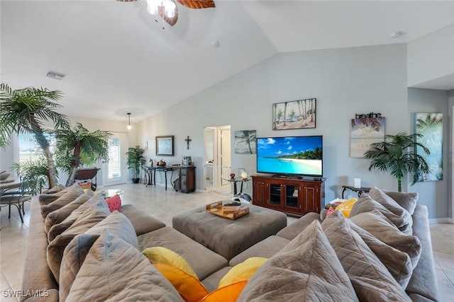 living area featuring light tile patterned floors, baseboards, visible vents, a ceiling fan, and high vaulted ceiling