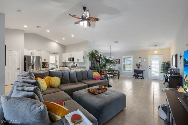 living area with light tile patterned floors, recessed lighting, visible vents, a ceiling fan, and vaulted ceiling