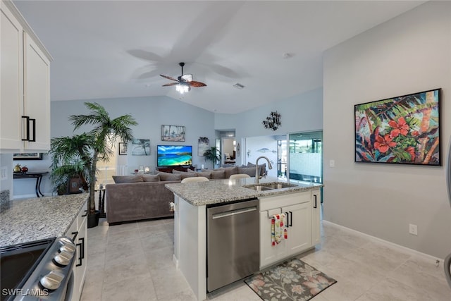 kitchen featuring appliances with stainless steel finishes, white cabinets, a sink, and open floor plan